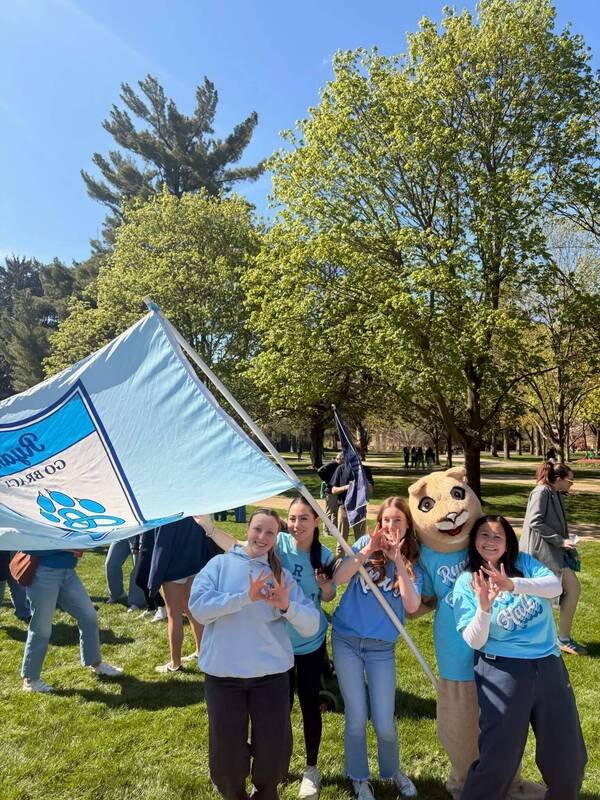 Photo from 2026 pep rally at The Rally. Ryan Hall showed up with lots of spirit, the Ryan Hall flag, everyone dressed in Ryan merchandise, and we even had Helen Easly in the catsuit.